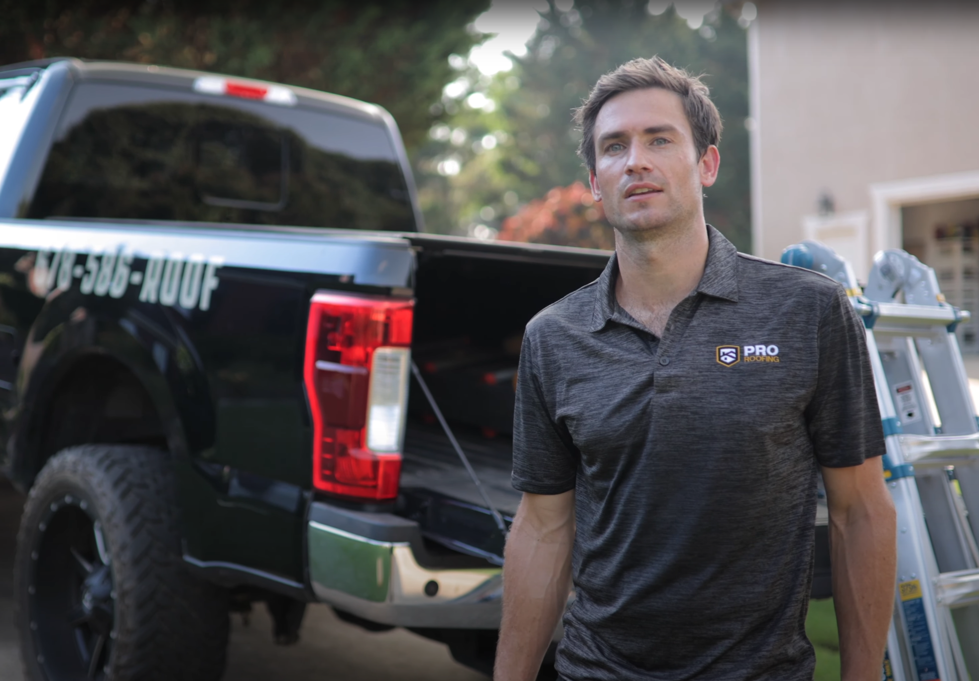 image of Cole, the owner of ProRoofing, standing by his truck explaining the free roof inspection process